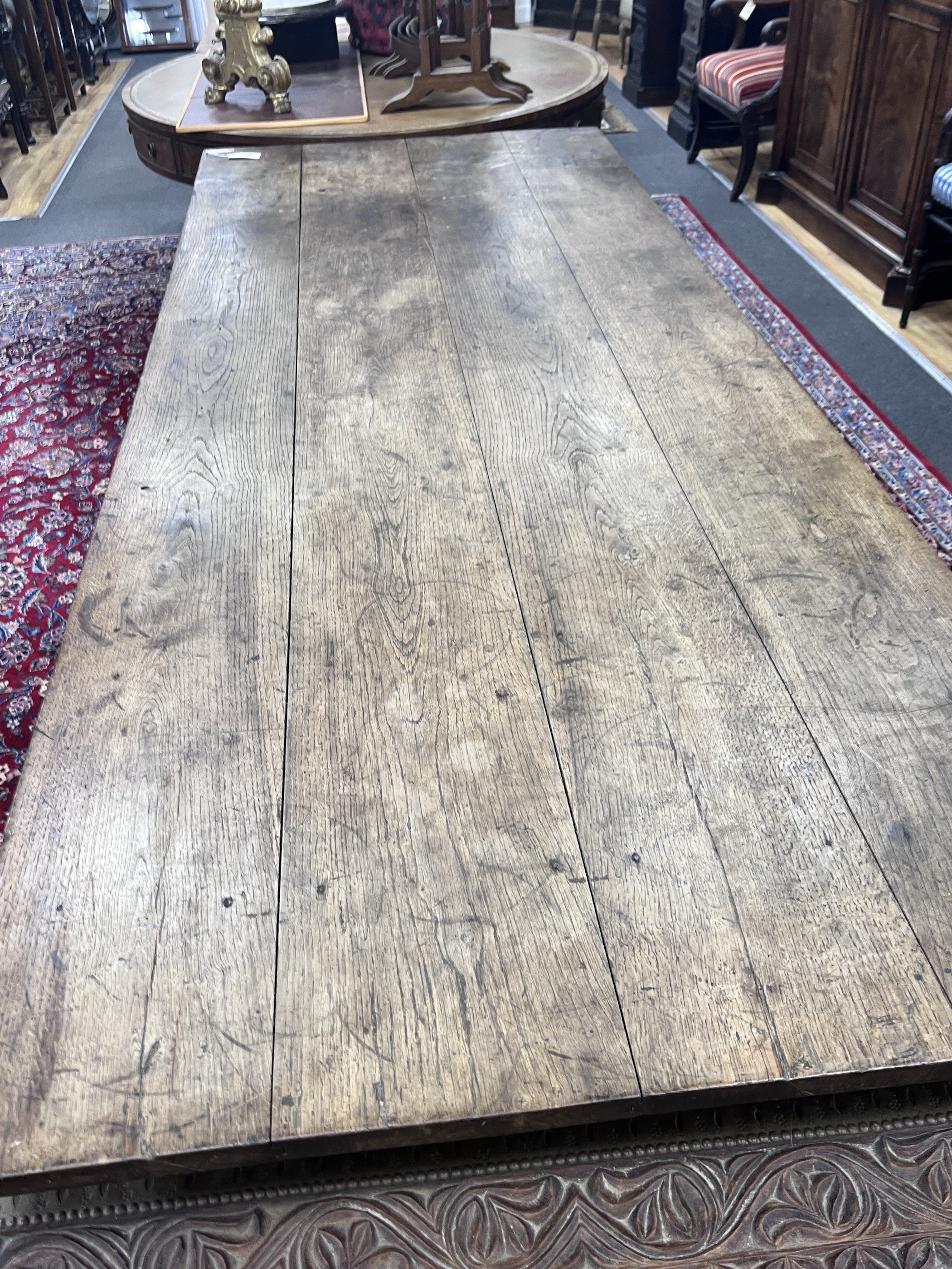A 19th century French oak two drawer farmhouse table with a four plank top, on square tapered legs, length 239cm, depth 93cm, height 74cm